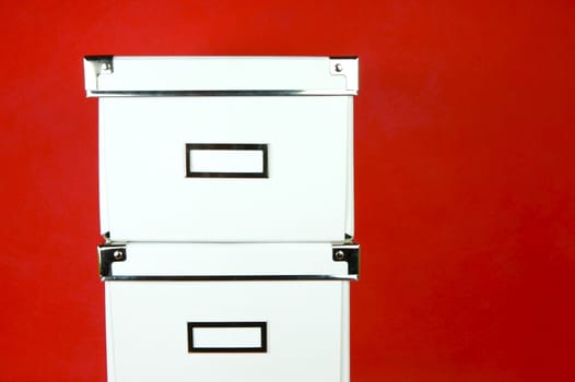 Storage boxes isolated against a red background