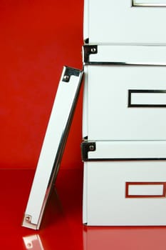 Storage boxes isolated against a red background