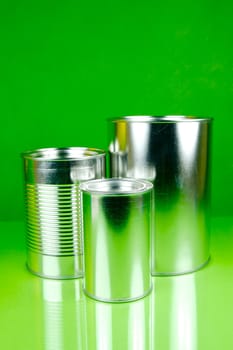 Storage tins isolated against a green background