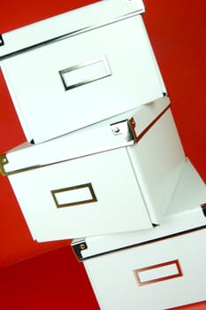 Storage boxes isolated against a red background