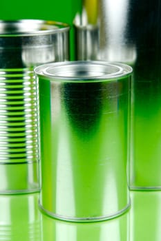 Storage tins isolated against a green background