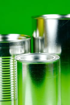 Storage tins isolated against a green background