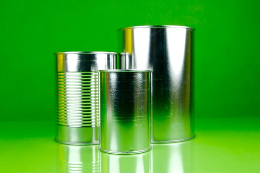 Storage tins isolated against a green background