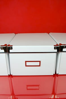 Storage boxes isolated against a red background