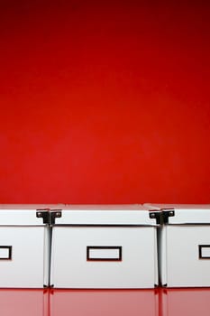 Storage boxes isolated against a red background