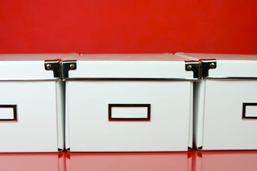 Storage boxes isolated against a red background