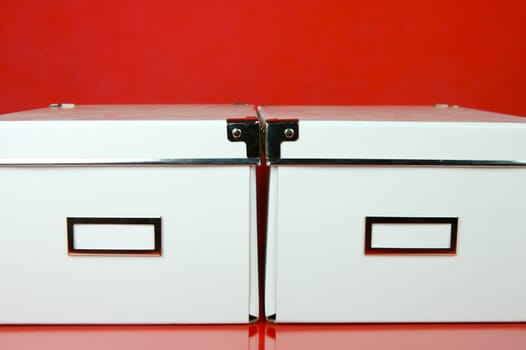 Storage boxes isolated against a red background