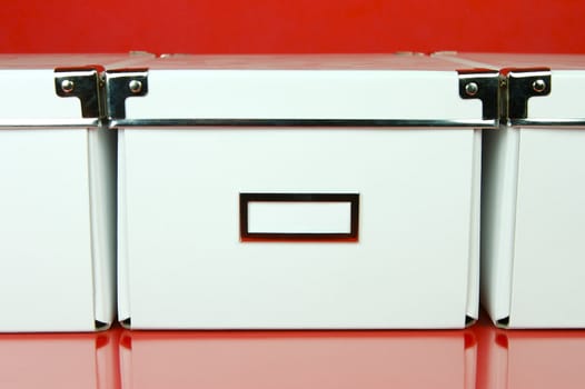 Storage boxes isolated against a red background