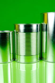 Storage tins isolated against a green background