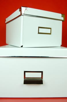 Storage boxes isolated against a red background