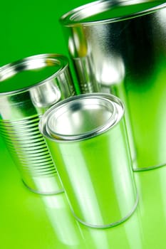 Storage tins isolated against a green background