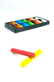 Oil pastels/crayons isolated against a white background