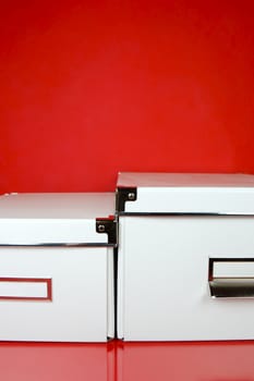 Storage boxes isolated against a red background