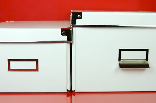 Storage boxes isolated against a red background