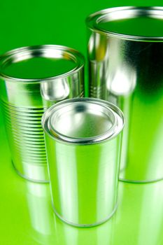 Storage tins isolated against a green background