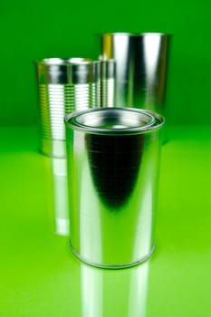 Storage tins isolated against a green background