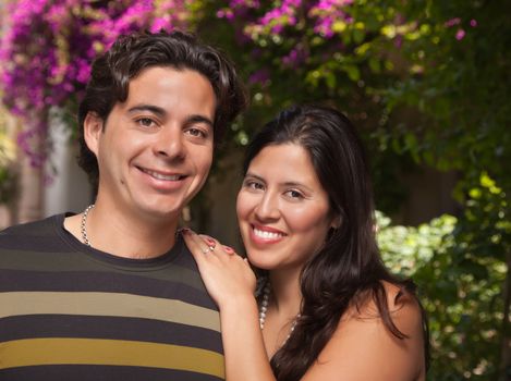 Attractive Hispanic Couple Portrait Enjoying Each Other Outdoors.