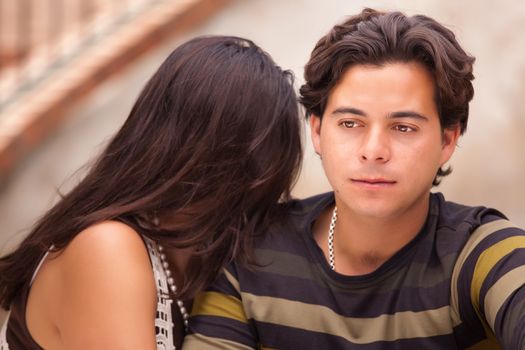 Attractive Hispanic Couple During A Serious Moment at a Fountain.