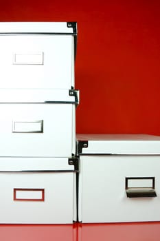 Storage boxes isolated against a red background