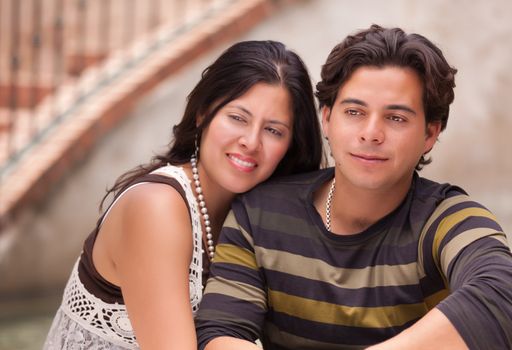 Attractive Hispanic Couple Portrait Enjoying Each Other Outdoors.