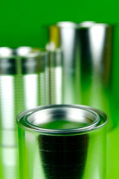 Storage tins isolated against a green background