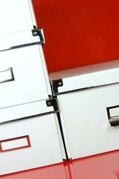 Storage boxes isolated against a red background