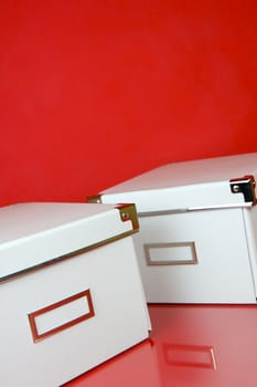 Storage boxes isolated against a red background