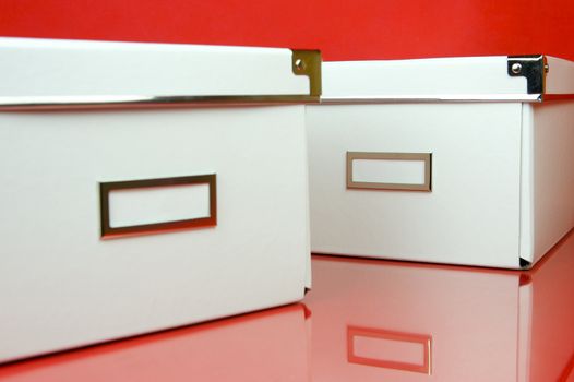 Storage boxes isolated against a red background