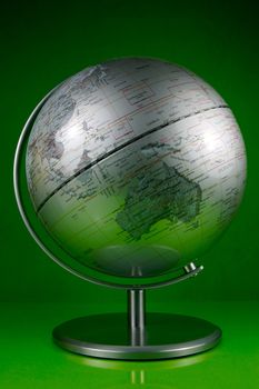 A world globe isolated against a green background