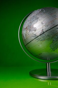 A world globe isolated against a green background