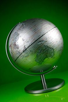 A world globe isolated against a green background