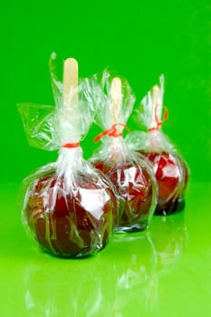 Candy apples isolated against a green background