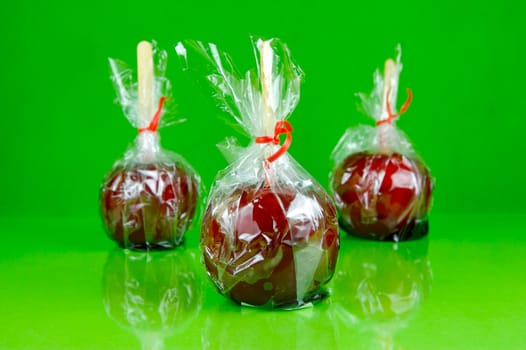 Candy apples isolated against a green background