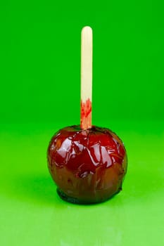 Candy apples isolated against a green background