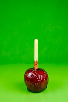 Candy apples isolated against a green background