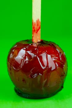 Candy apples isolated against a green background