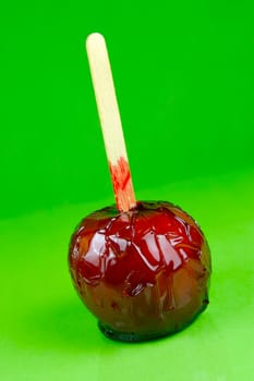 Candy apples isolated against a green background