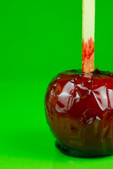 Candy apples isolated against a green background