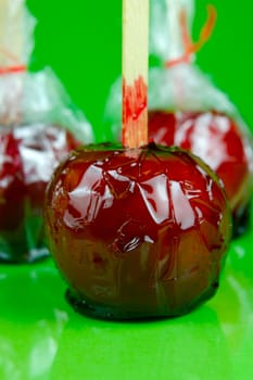 Candy apples isolated against a green background