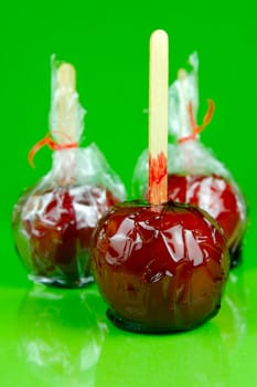 Candy apples isolated against a green background