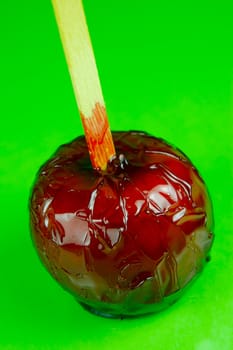 Candy apples isolated against a green background