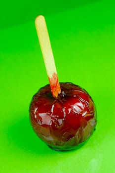 Candy apples isolated against a green background