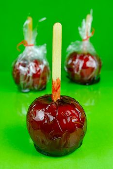 Candy apples isolated against a green background