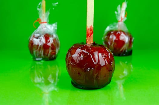 Candy apples isolated against a green background