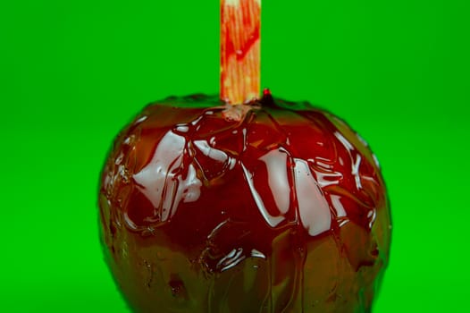 Candy apples isolated against a green background