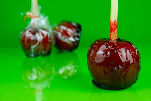 Candy apples isolated against a green background