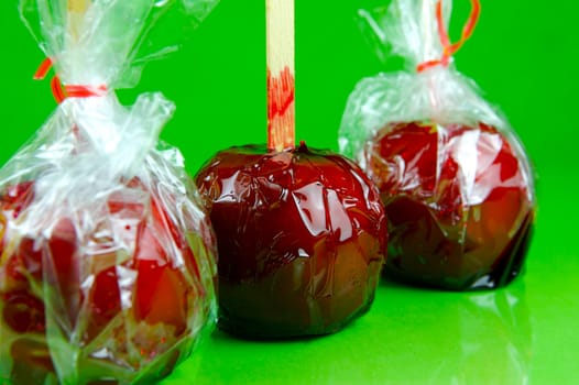 Candy apples isolated against a green background