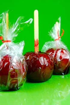 Candy apples isolated against a green background