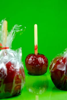 Candy apples isolated against a green background