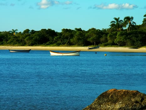 Small fisher boats anchored on a calm beach